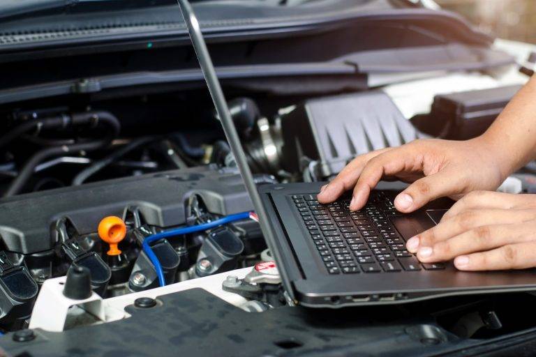 someone running diagnostics on a car