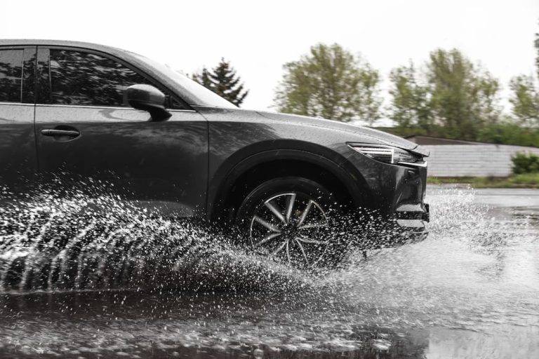 car driving through a big puddle